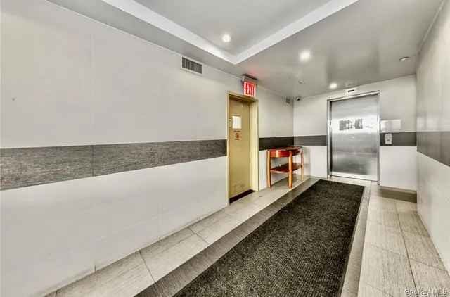 a kitchen with stainless steel appliances kitchen island granite countertop a stove a sink and a refrigerator