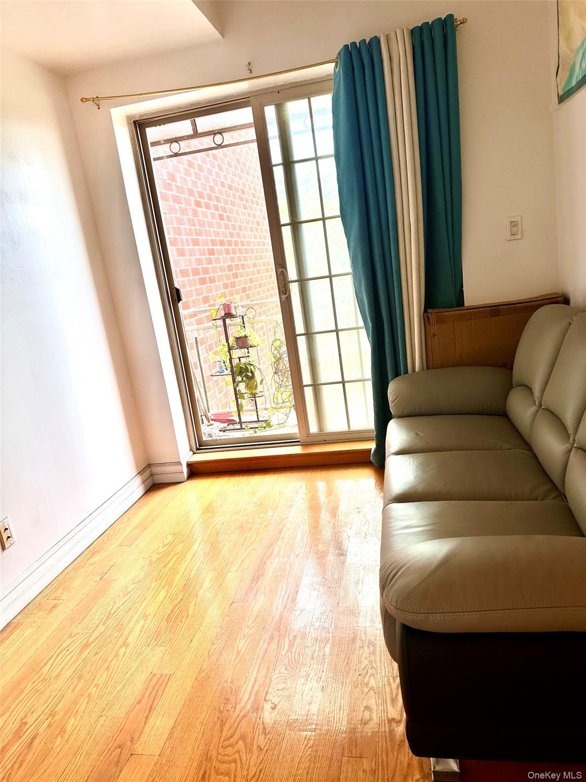 107-16 37th Avenue, Unit 4B Queens, NY 11368 - Photo 8 of 13 a living room with a large window