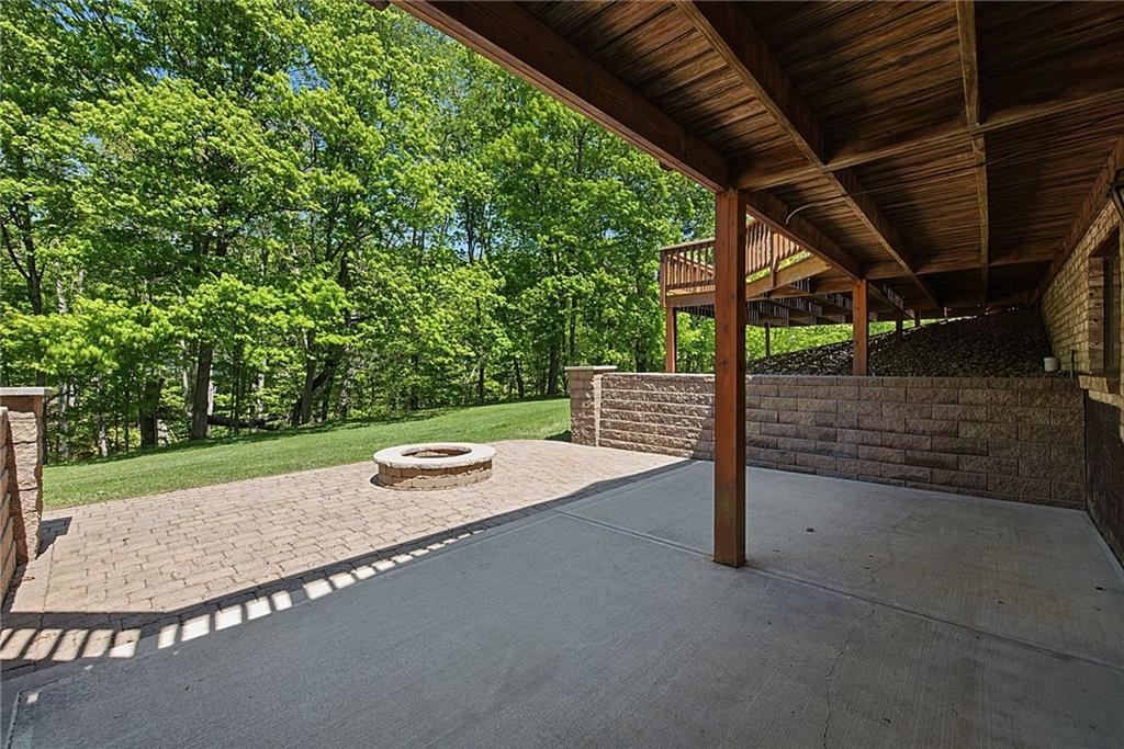 388 Bortz Road Saltsburg, PA 15681 - Photo 32 of 50 20x18 Custom Stone Patio with Built in Fire-Pit! (+Loads of wood piled on property)
