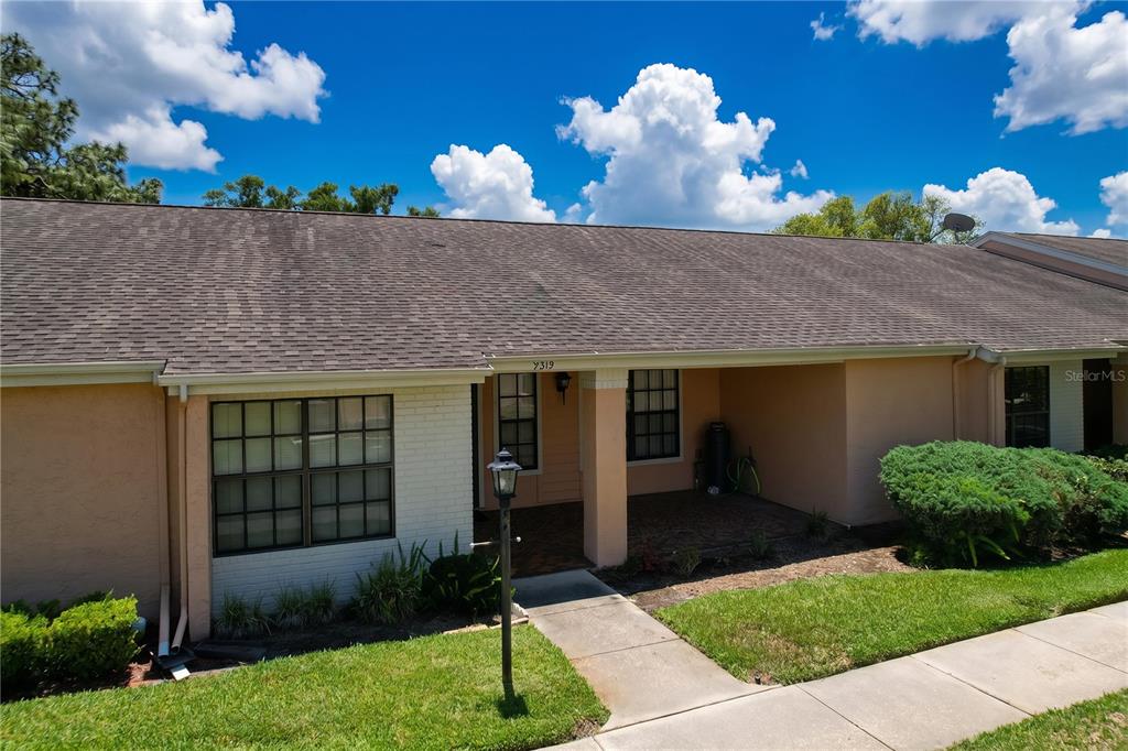 9319 Trowbridge Court New Port Richey, FL 34655 - Photo 1 of 78 a front view of a house with a yard and a garden