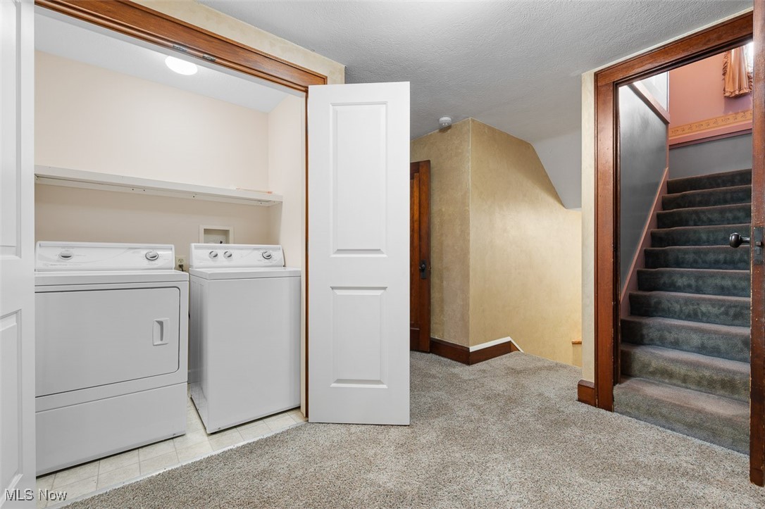256 Everhard Road Southwest North Canton, OH 44709 - Photo 24 of 45 Laundry area with light colored carpet, separate washer and dryer, a textured ceiling, and light tile patterned floors