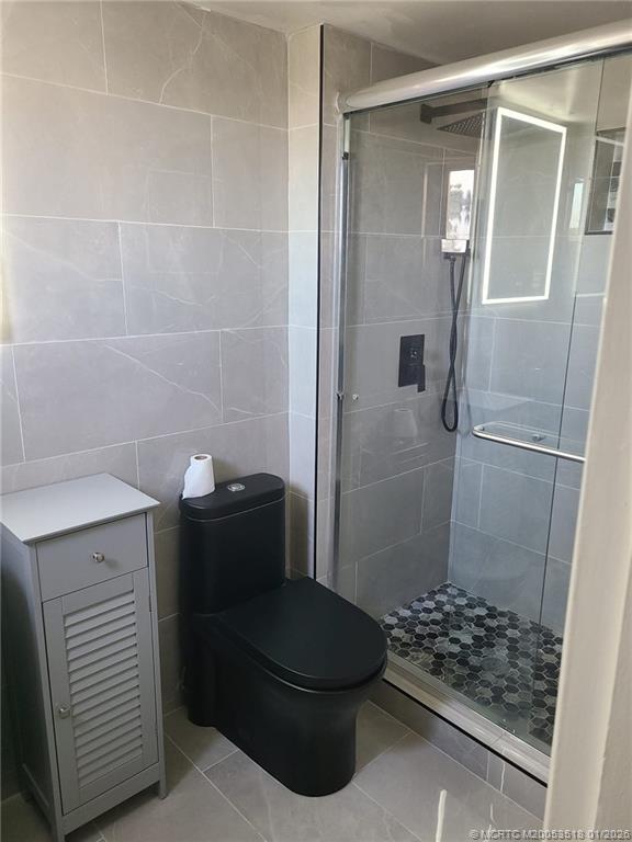 13715 Southwest 66th Street, Unit 415 Miami, FL 33183 - Photo 13 of 20 a bathroom with a sink a toilet and shower