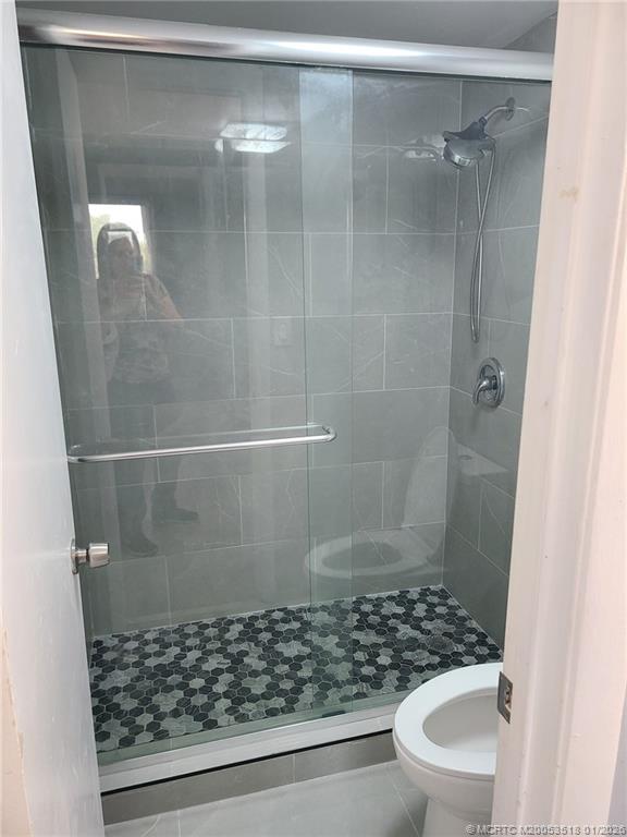 13715 Southwest 66th Street, Unit 415 Miami, FL 33183 - Photo 17 of 20 a bathroom with a shower and a toilet