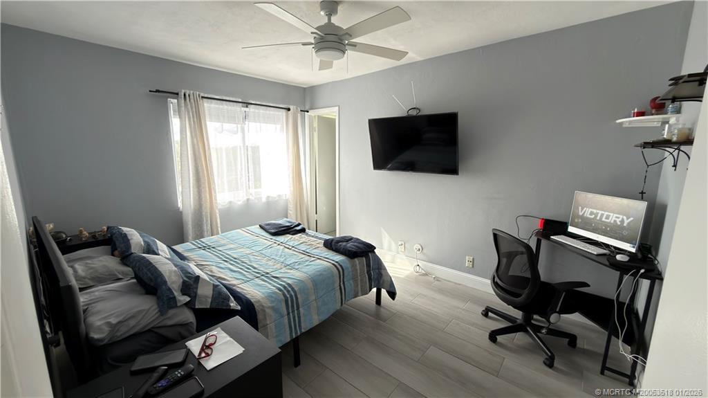 13715 Southwest 66th Street, Unit 415 Miami, FL 33183 - Photo 3 of 20 a bedroom with bed and a flat screen tv