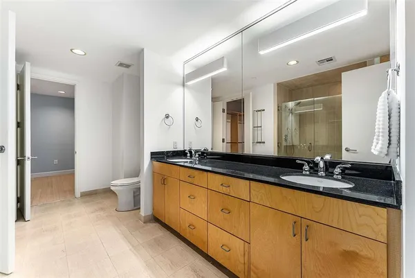 a bathroom with a sink a toilet and mirror