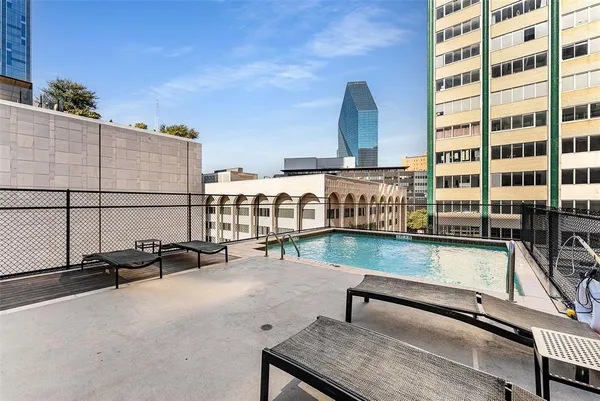 a roof deck with tall wooden cabinets and outdoor seating