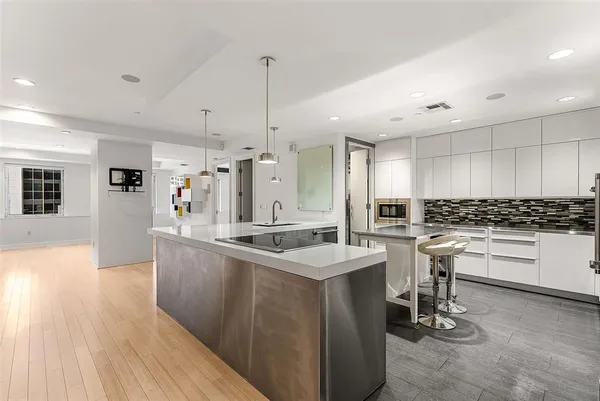 a kitchen with a sink stainless steel appliances and cabinets