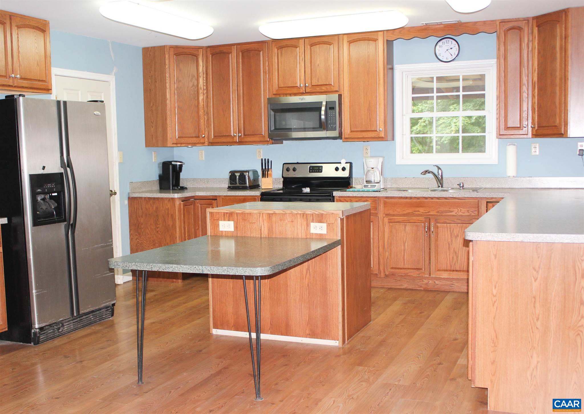 3205 Community House Road Columbia, VA 23038 - Photo 6 of 14 a kitchen with stainless steel appliances granite countertop a stove a refrigerator a sink and a microwave