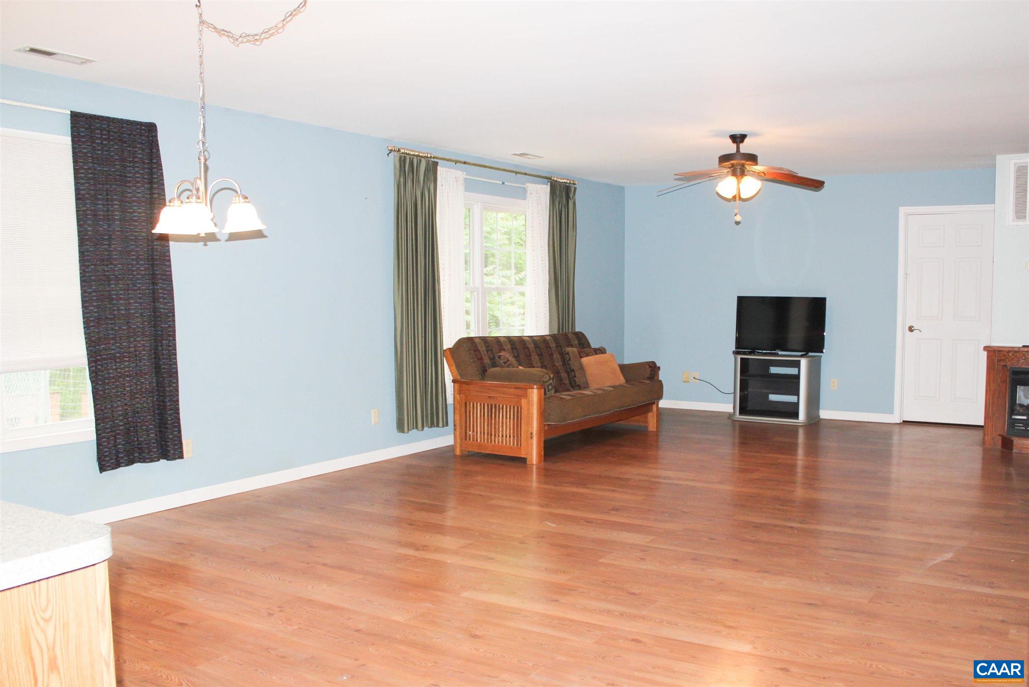 3205 Community House Road Columbia, VA 23038 - Photo 7 of 14 a living room with furniture and wooden floor