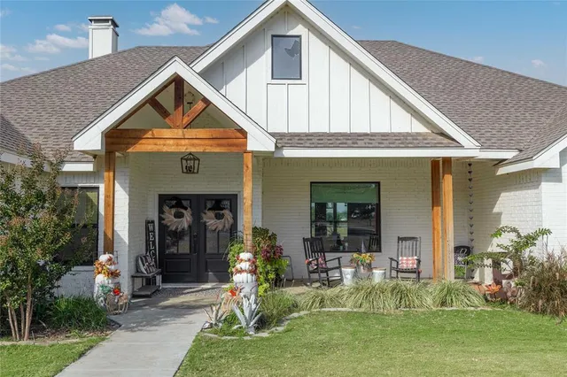 a front view of a house with a yard potted plants