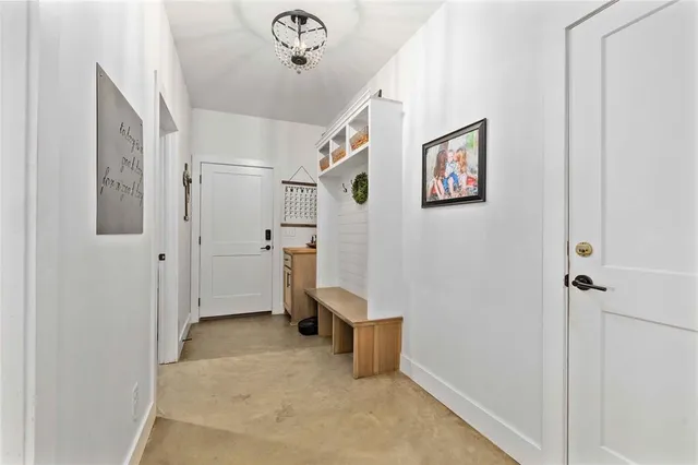 a living room with furniture a flat screen tv and a large window