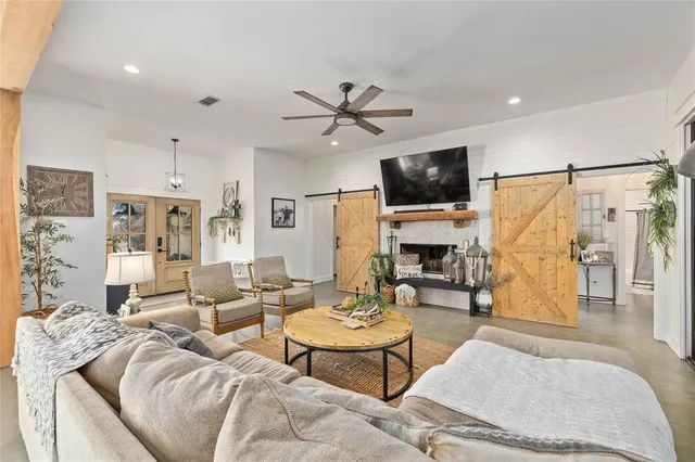 a living room with furniture a flat screen tv and a fireplace