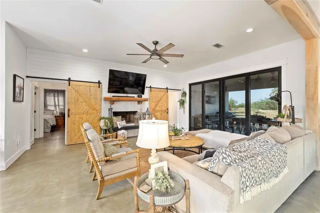 a living room with fireplace furniture and a flat screen tv
