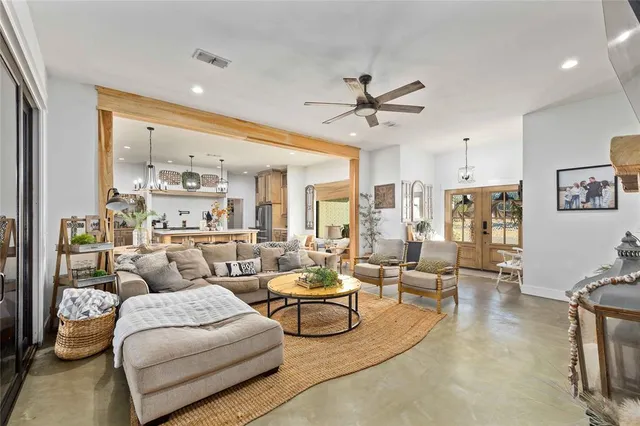 a living room with furniture and a large window
