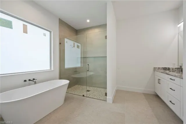 a bathroom with a granite countertop toilet a sink and shower