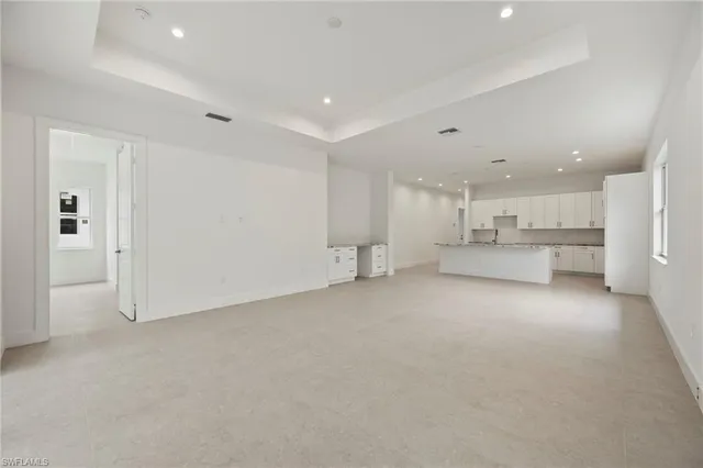 a view of an empty room with a window and a ceiling fan
