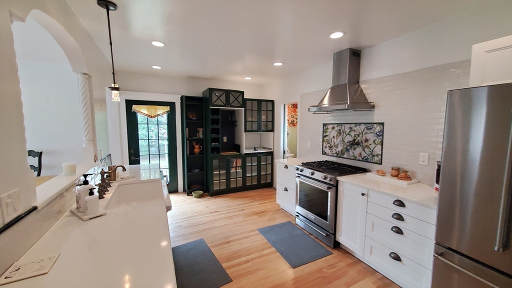 68 Clark Street Worcester, MA 01606 - Photo 11 of 42 a kitchen with stainless steel appliances granite countertop a stove and a refrigerator