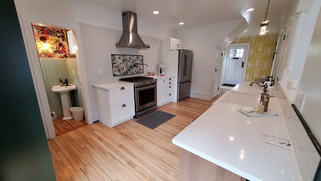 68 Clark Street Worcester, MA 01606 - Photo 12 of 42 a kitchen with stainless steel appliances a sink stove and cabinets