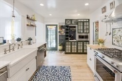 68 Clark Street Worcester, MA 01606 - Photo 13 of 42 a kitchen with stainless steel appliances kitchen island granite countertop a refrigerator and a sink