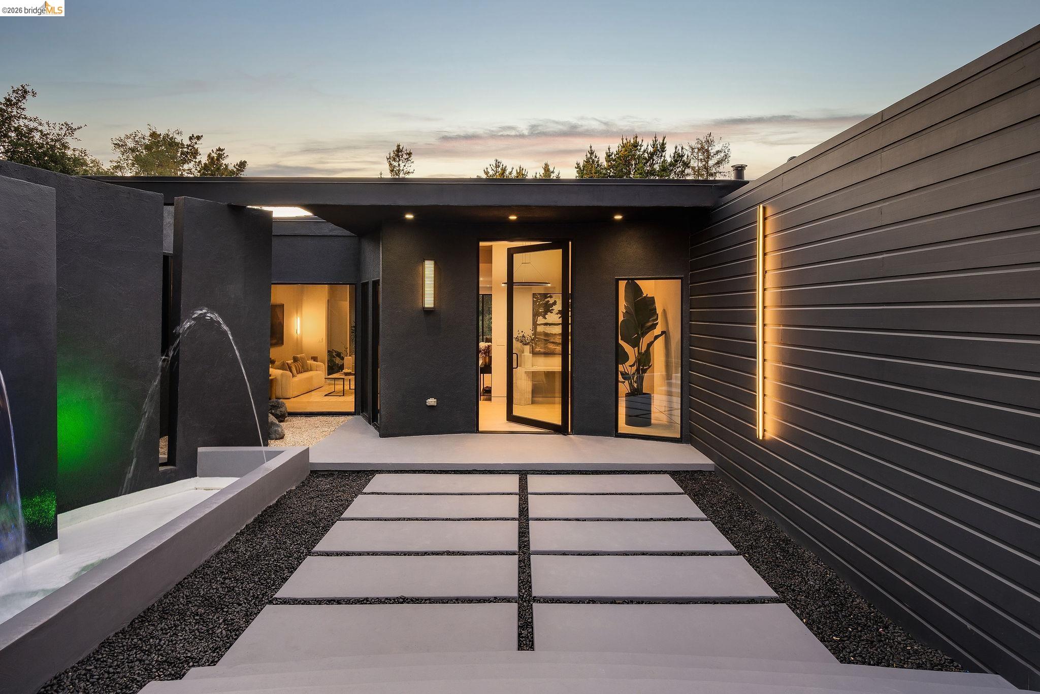 5645 Bacon Road Oakland, CA 94619 - Photo 7 of 94 Contemporary exterior featuring dark horizontal siding and a clean-lined concrete walkway
