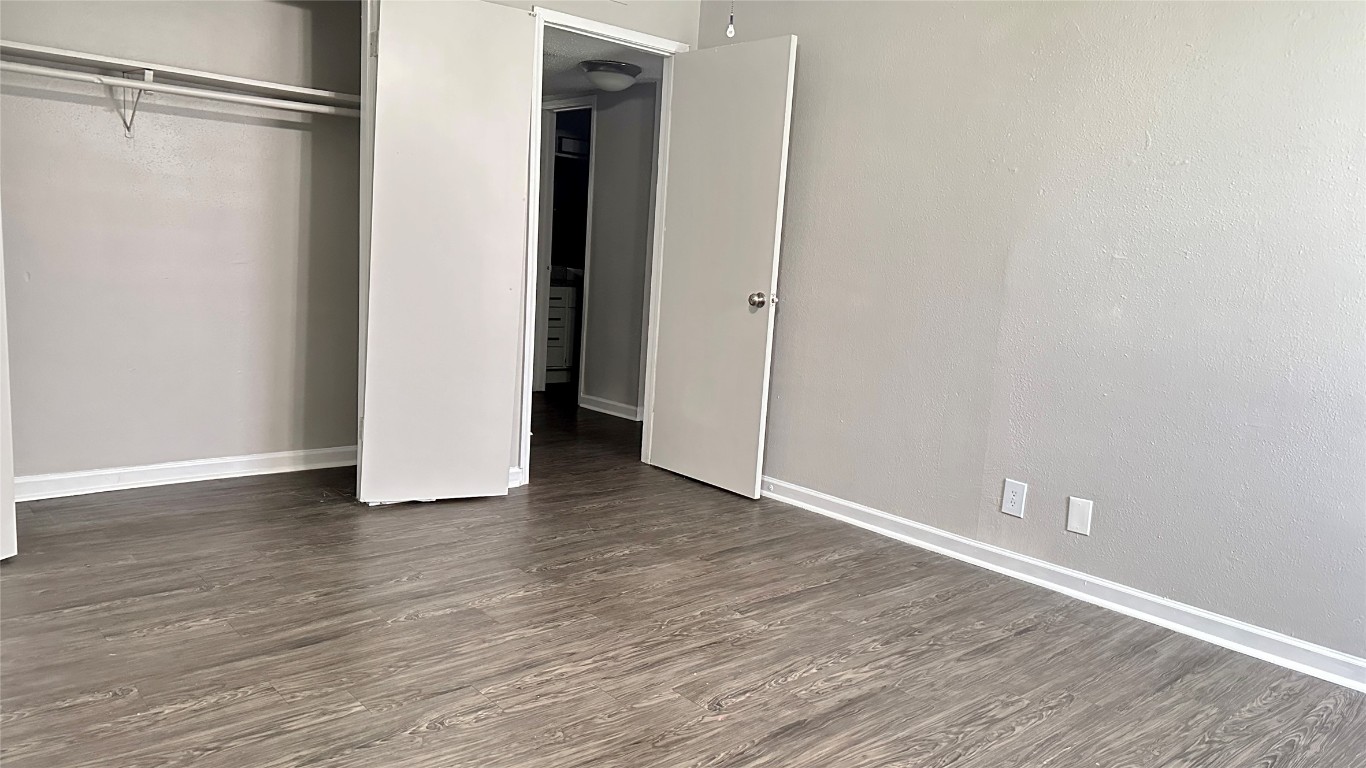 5426 Menchaca Road, Unit 216 Austin, TX 78745 - Photo 2 of 11 a view of an empty room with wooden floor and a window