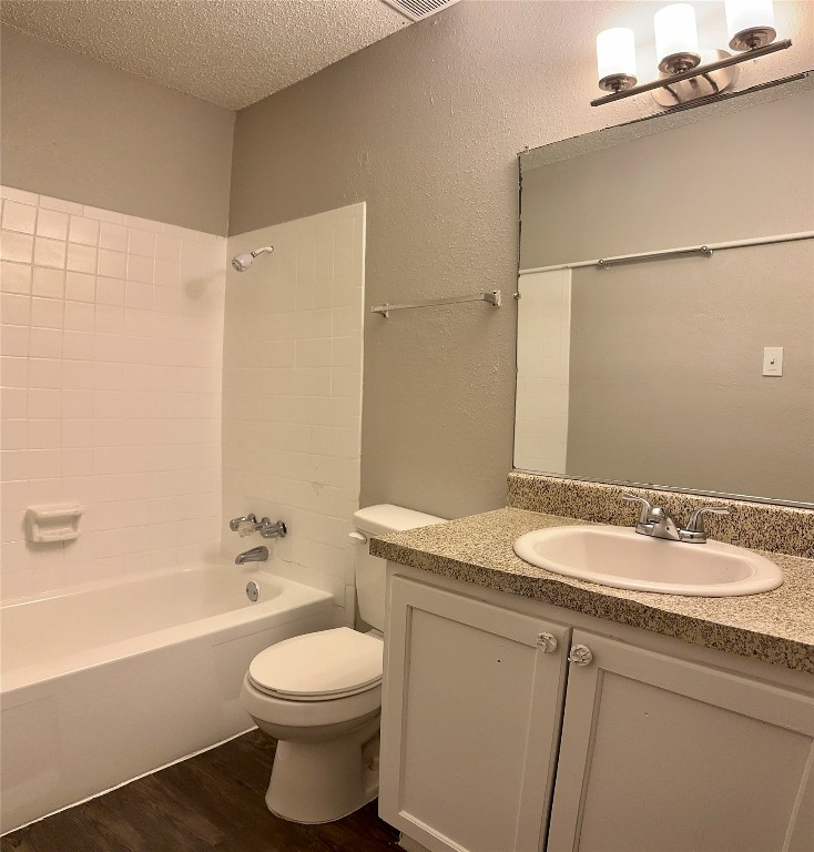 5426 Menchaca Road, Unit 216 Austin, TX 78745 - Photo 6 of 11 a bathroom with a granite countertop sink toilet a mirror and shower
