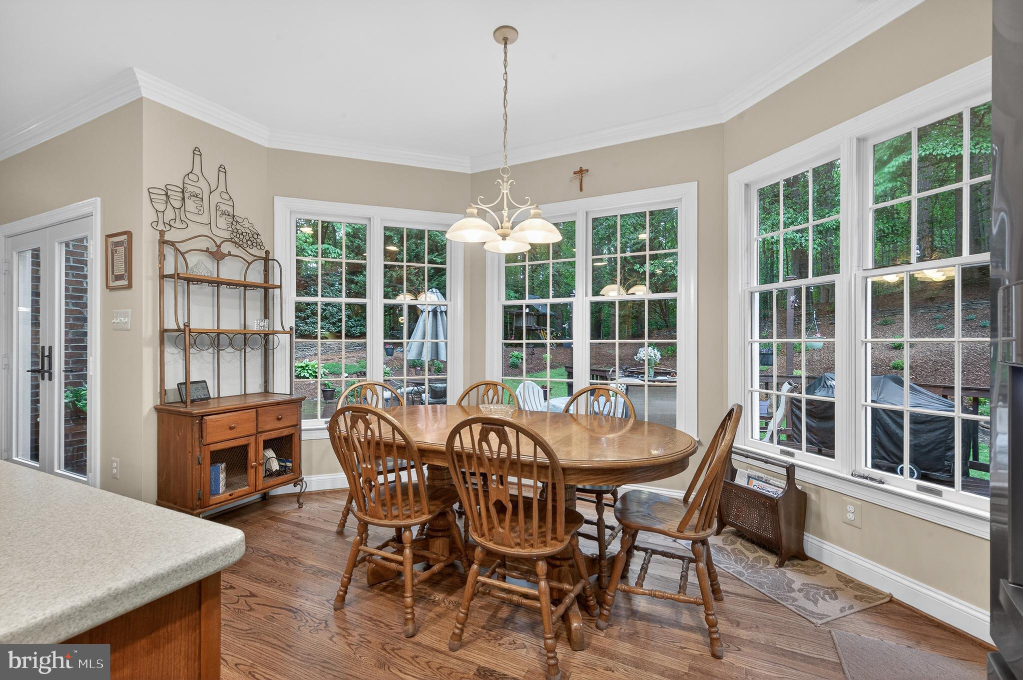 6601 Colchester Road Fairfax Station, VA 22039 - Photo 20 of 78 a view of a dining room with furniture large windows and wooden floor