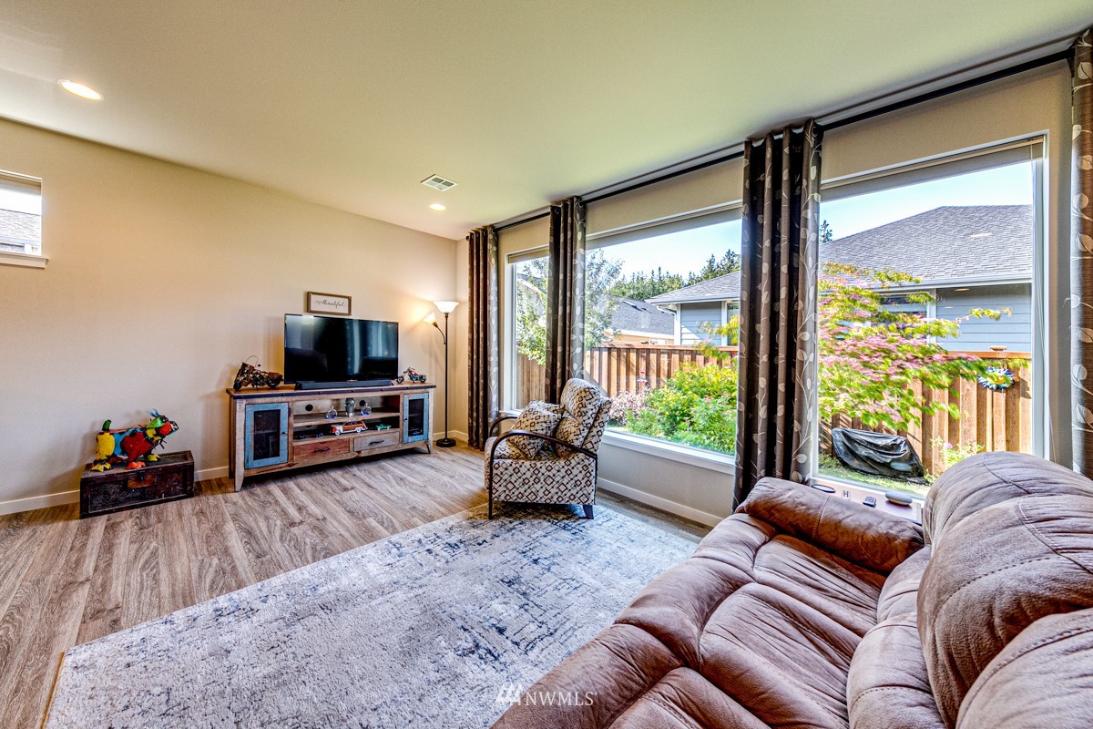 431 Lofgrin Road Sequim, WA 98382 - Photo 16 of 35 a living room with furniture and a flat screen tv