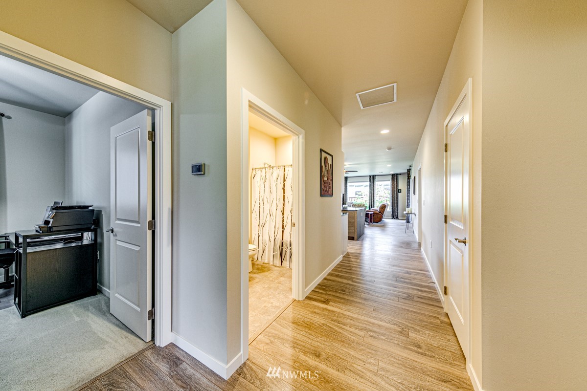 431 Lofgrin Road Sequim, WA 98382 - Photo 18 of 35 a view of a hallway with wooden floor and a living room