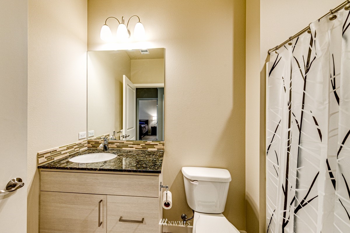 431 Lofgrin Road Sequim, WA 98382 - Photo 20 of 35 a bathroom with a granite countertop sink and a mirror