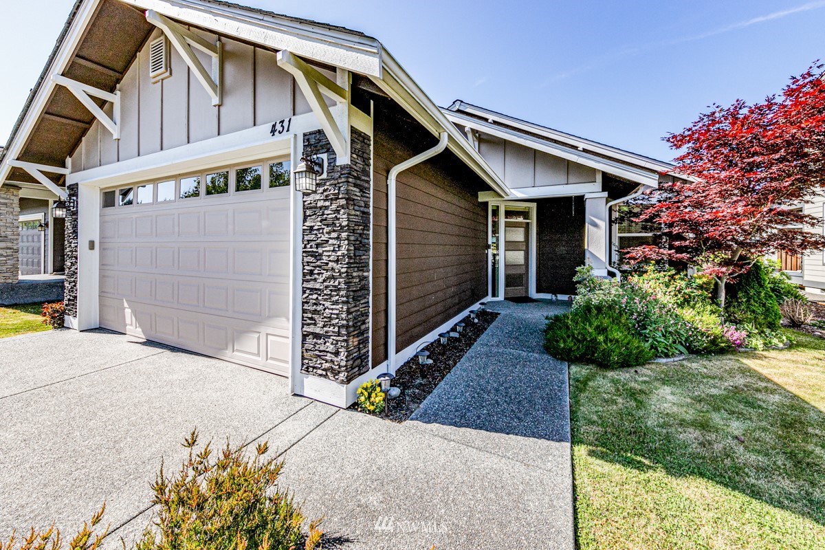 431 Lofgrin Road Sequim, WA 98382 - Photo 2 of 35 a view of a white house with a large windows and flower plants in front of main door