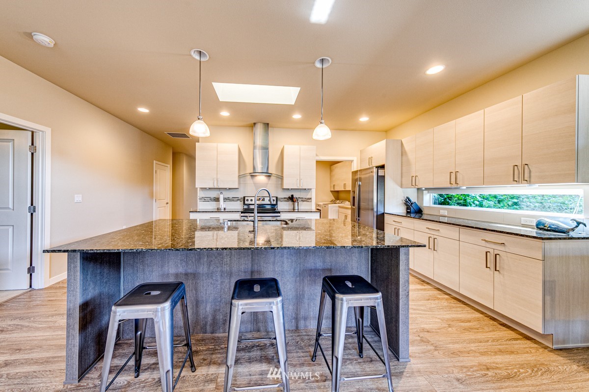 431 Lofgrin Road Sequim, WA 98382 - Photo 6 of 35 a large kitchen with a table and chairs in it