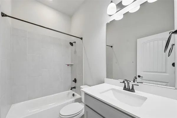 a bathroom with a sink toilet tub and shower