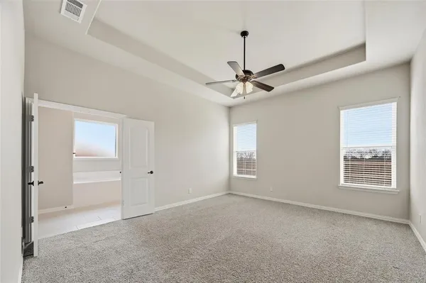 a view of a livingroom with a ceiling fan and window