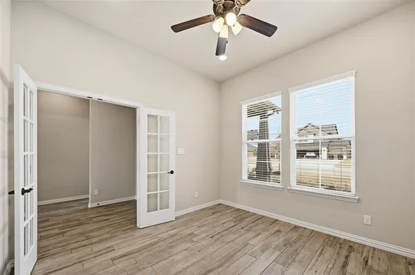 wooden floor in an empty room with a window