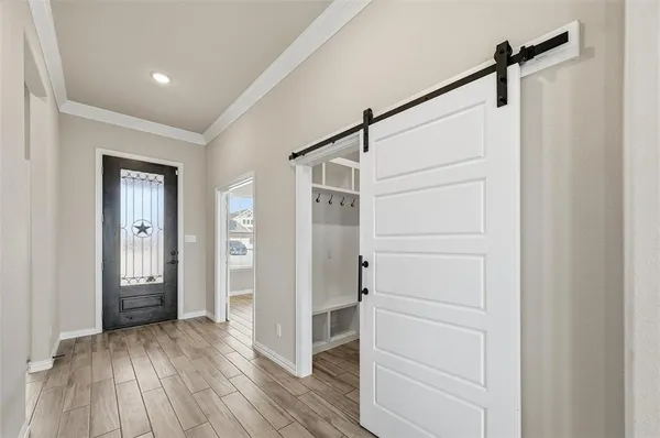 a view of walk in closet with wooden floor