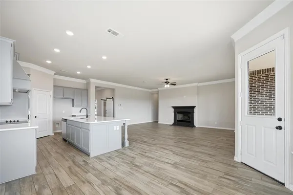 a view of a kitchen with furniture and wooden floor