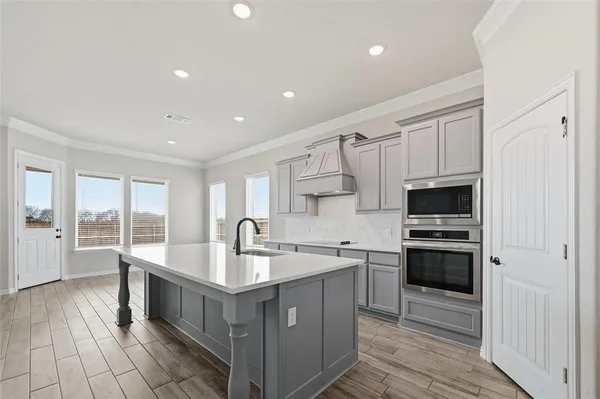 a kitchen with stainless steel appliances granite countertop a sink and cabinets