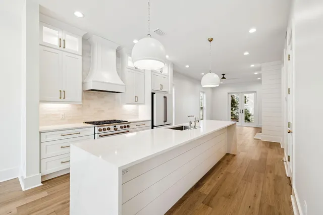 a large white kitchen with a large window