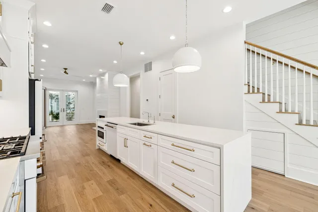 a kitchen with granite countertop a stove and a refrigerator
