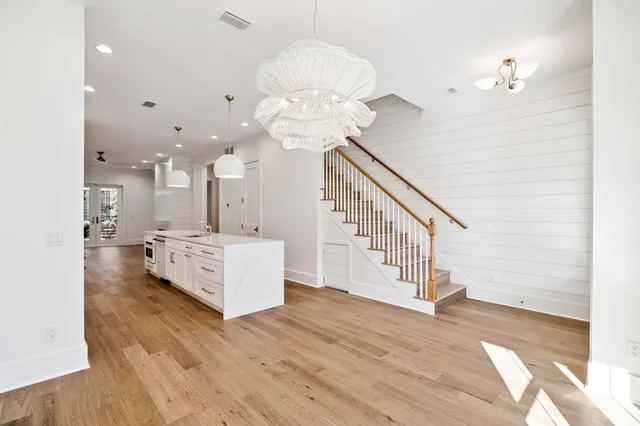 a view of a kitchen with furniture and wooden floor