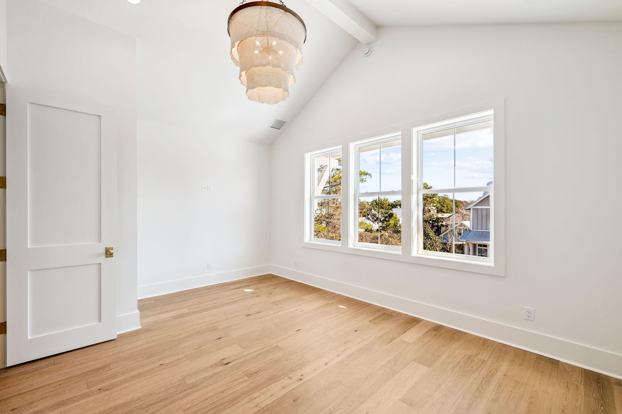 141 Grande Pointe Dr Inlet Beach Inlet Beach, FL 32461 - Photo 28 of 64 an empty room with wooden floor fan and windows