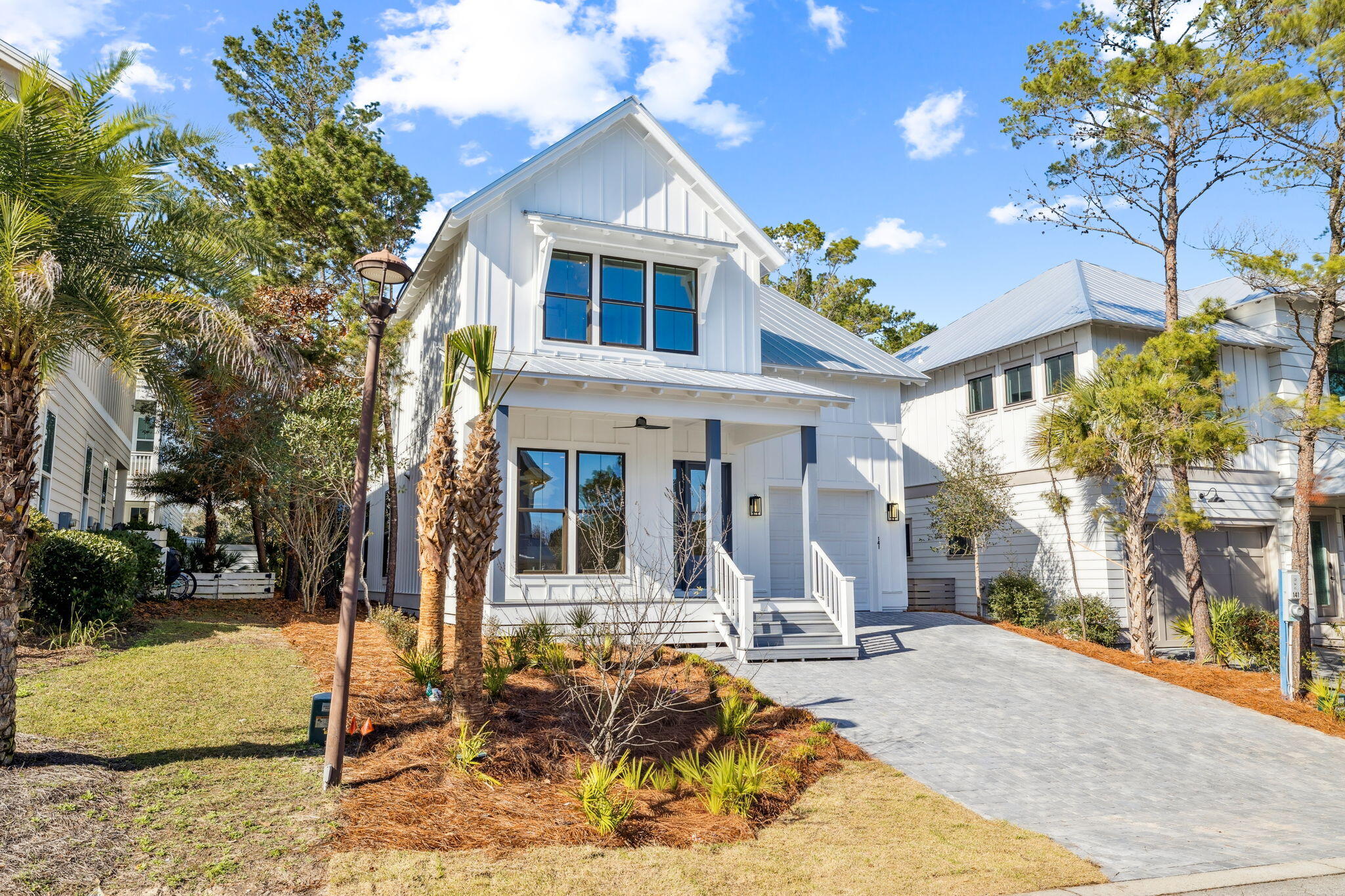 141 Grande Pointe Dr Inlet Beach Inlet Beach, FL 32461 - Photo 3 of 64 a view of a white house with large windows next to a road