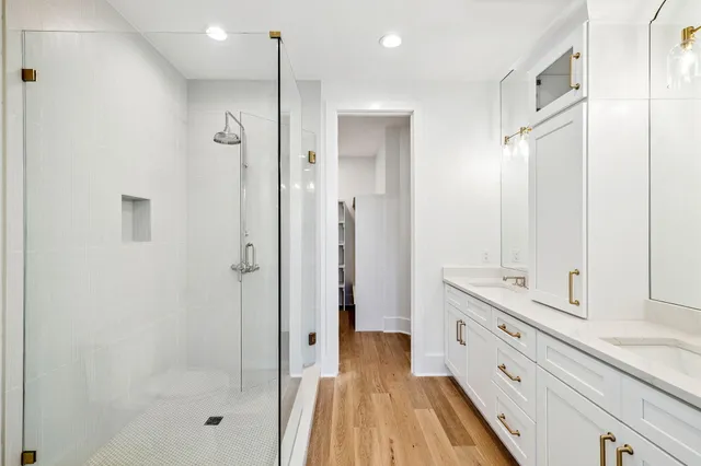 a view of a room with wooden floor and ceiling fan