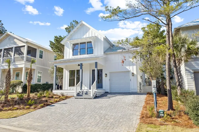 a view of a swimming pool with lawn chairs under an umbrella