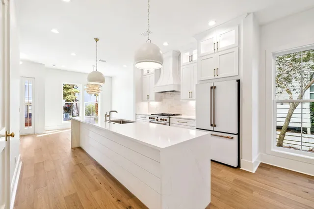 a kitchen with stainless steel appliances a stove and a chandelier