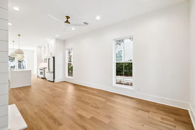 a large kitchen with kitchen island a stove a sink a center island and wooden floor