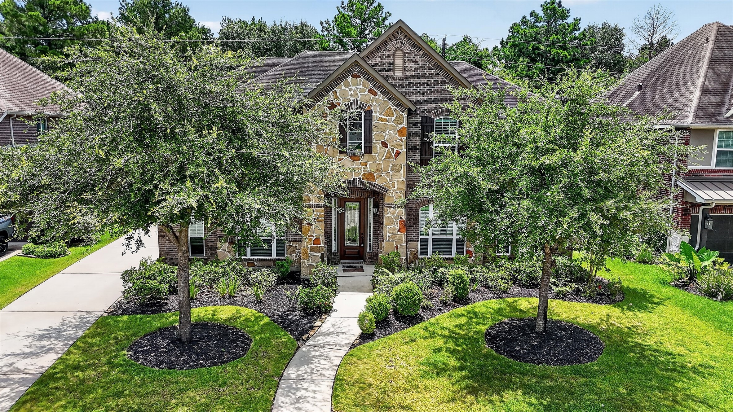 6234 Avon Landing Lane Spring, TX 77379 - Photo 2 of 49 Great curb appeal with established shade trees framing the walkway to the entry of the home. The home is zoned to Klein ISD.