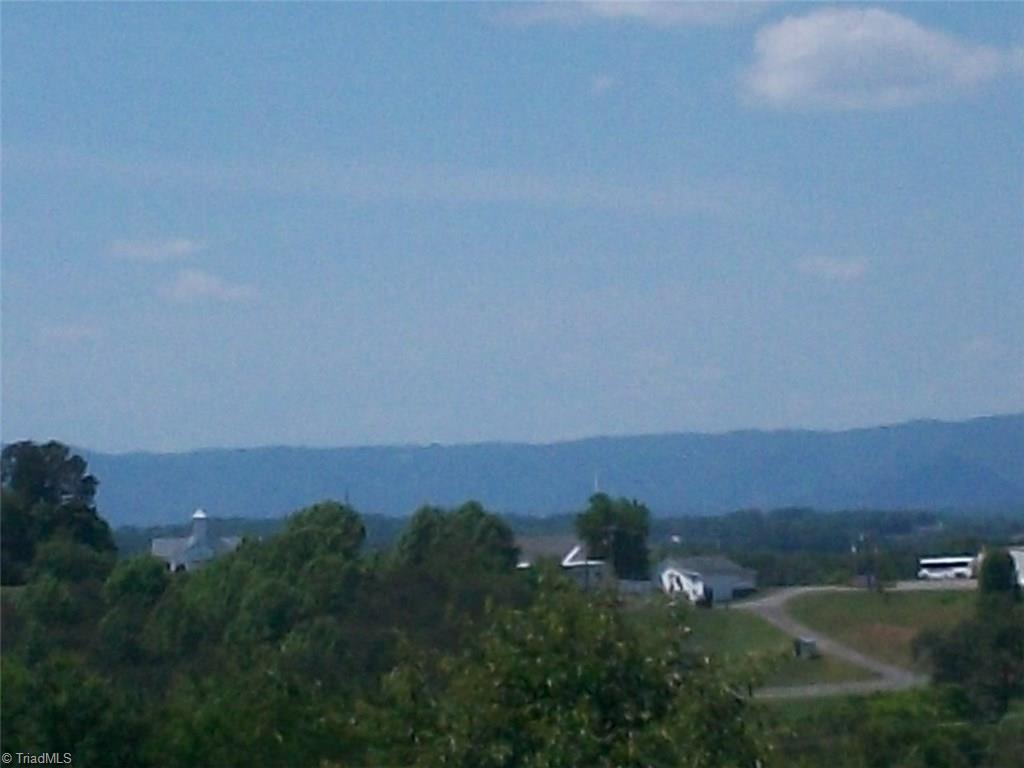 1-acre High Ridge Road Mount Airy, NC 27030 - Photo 1 of 13 View of the Blue Ridge Mountains in the distance.