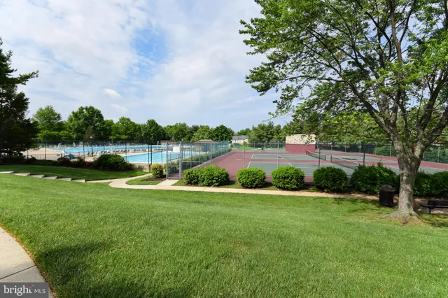 a view of a field with trees in the background